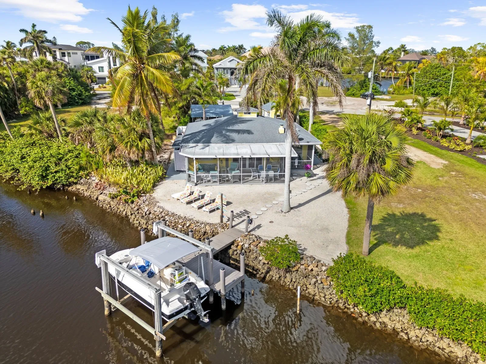 Drone photo of a waterfront home with a private dock and boat lift