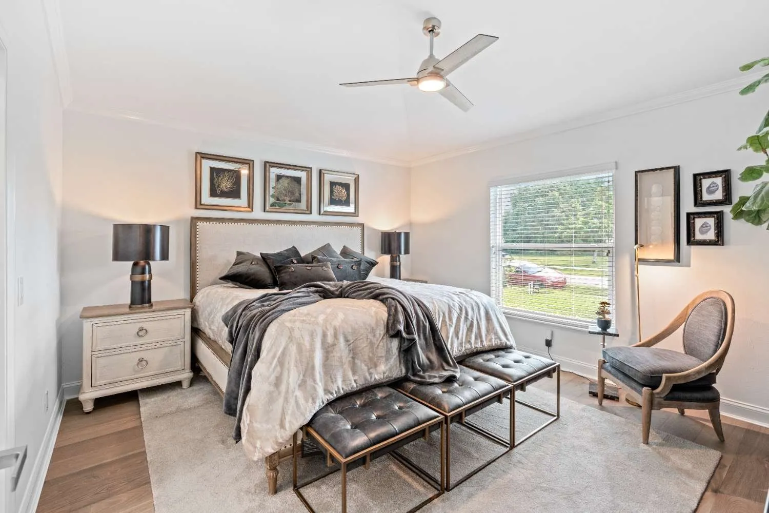 Bedroom with a gallery wall and upholstered chair
