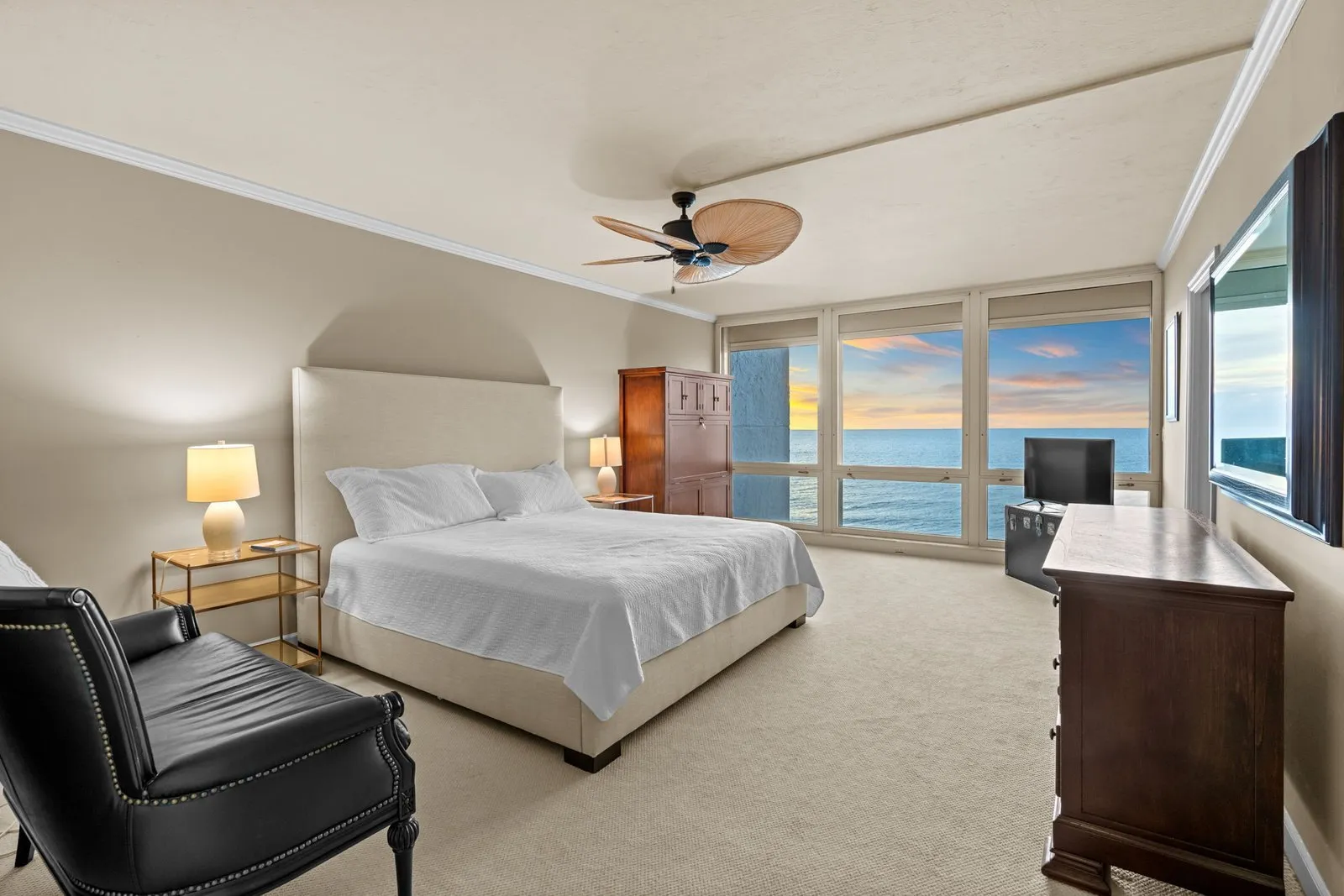 Bedroom with a sitting area and ceiling fan