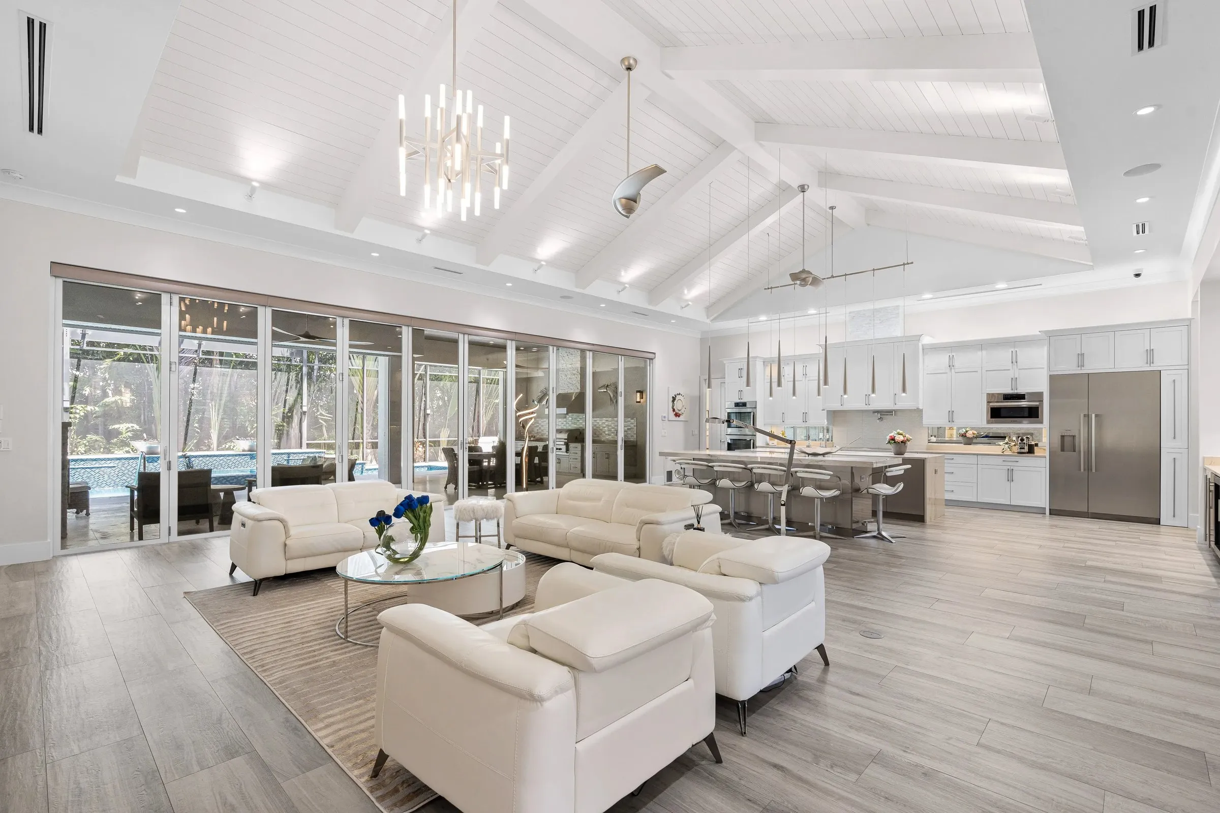 Great room open to the kitchen with a chandelier