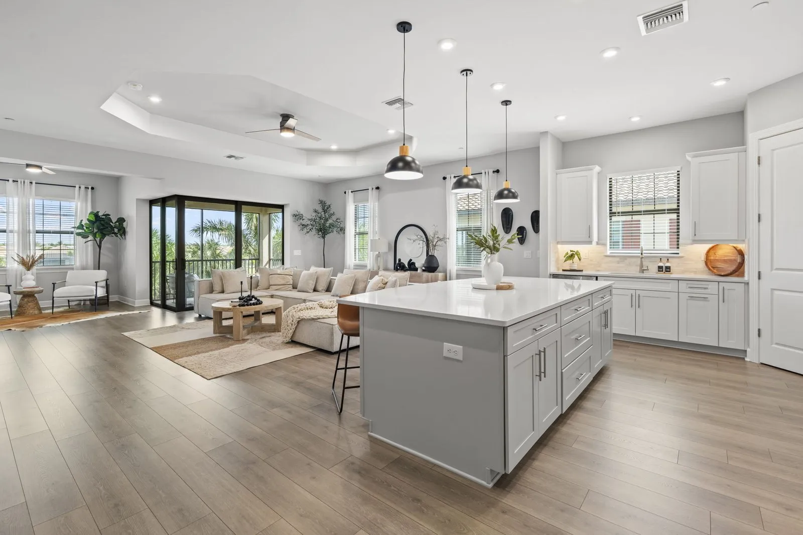Kitchen with a gray island and white cabinets