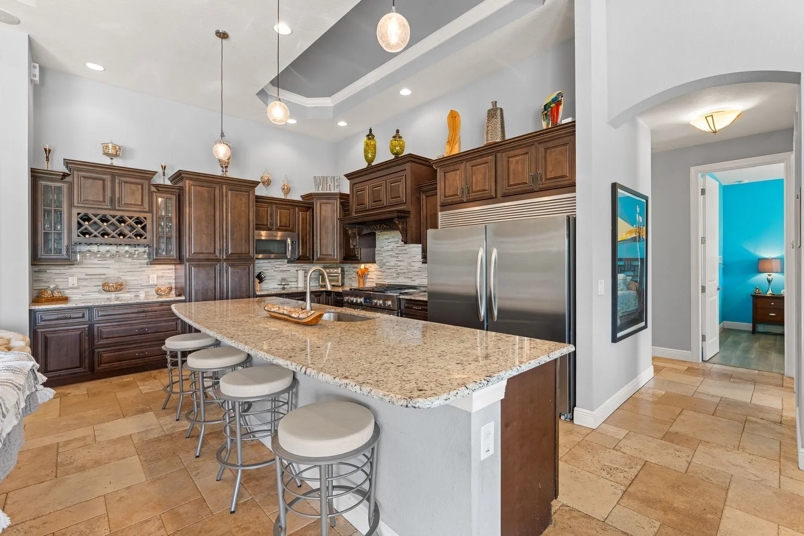 Kitchen with wood cabinetry, granite counters and a breakfast bar