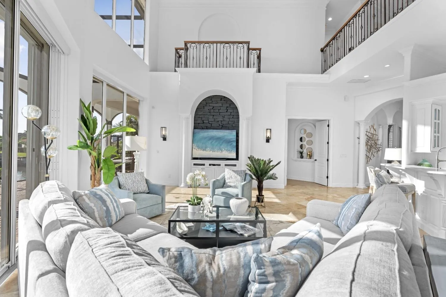 Living room with arched windows and white sofas