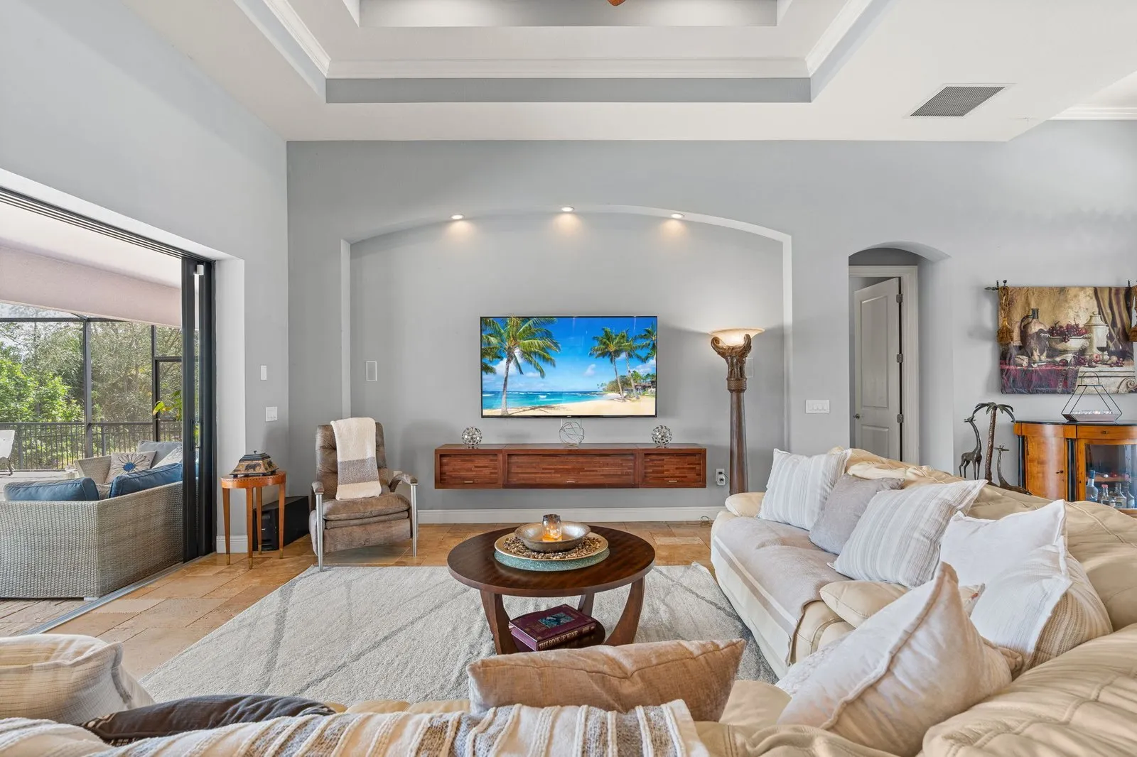 Bright coastal living room with a view of the pool