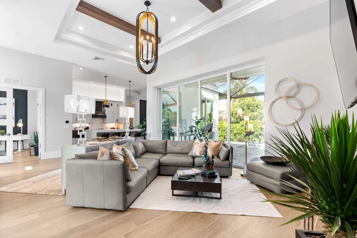 Living room with a modern chandelier and open kitchen