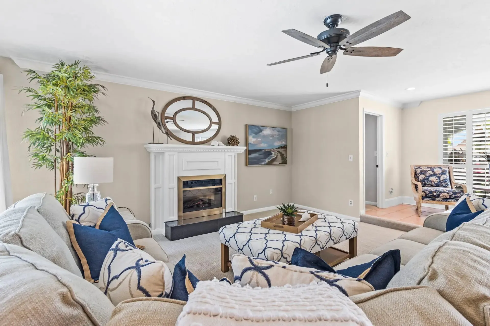 Living room with a round mirror and neutral decor