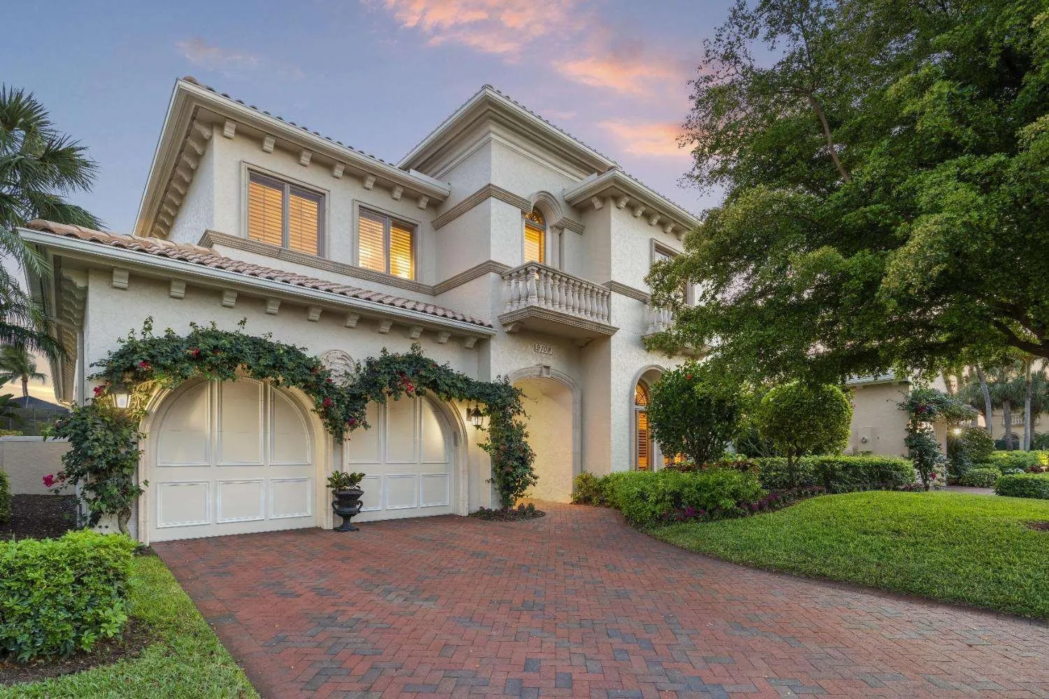 Mediterranean-style home with an arched entry and paver drive
