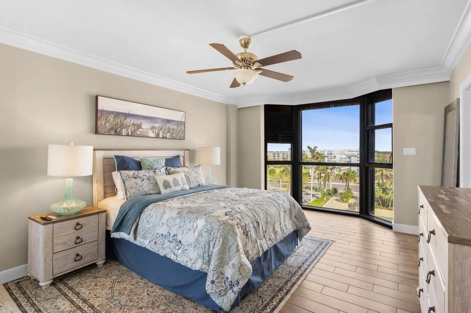 Primary bedroom with large windows and a water view