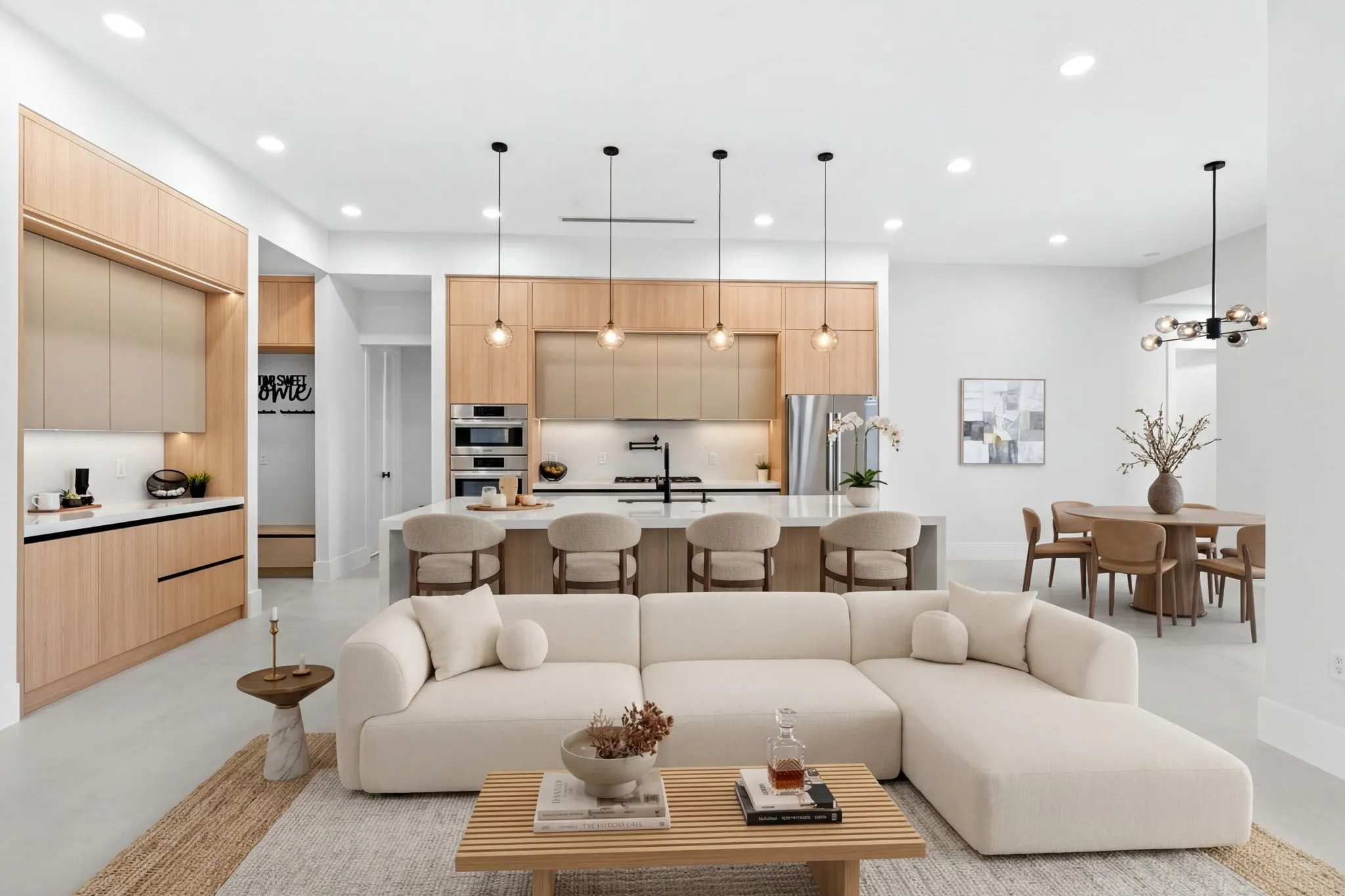 The same great room virtually staged with a sectional sofa and a dining table