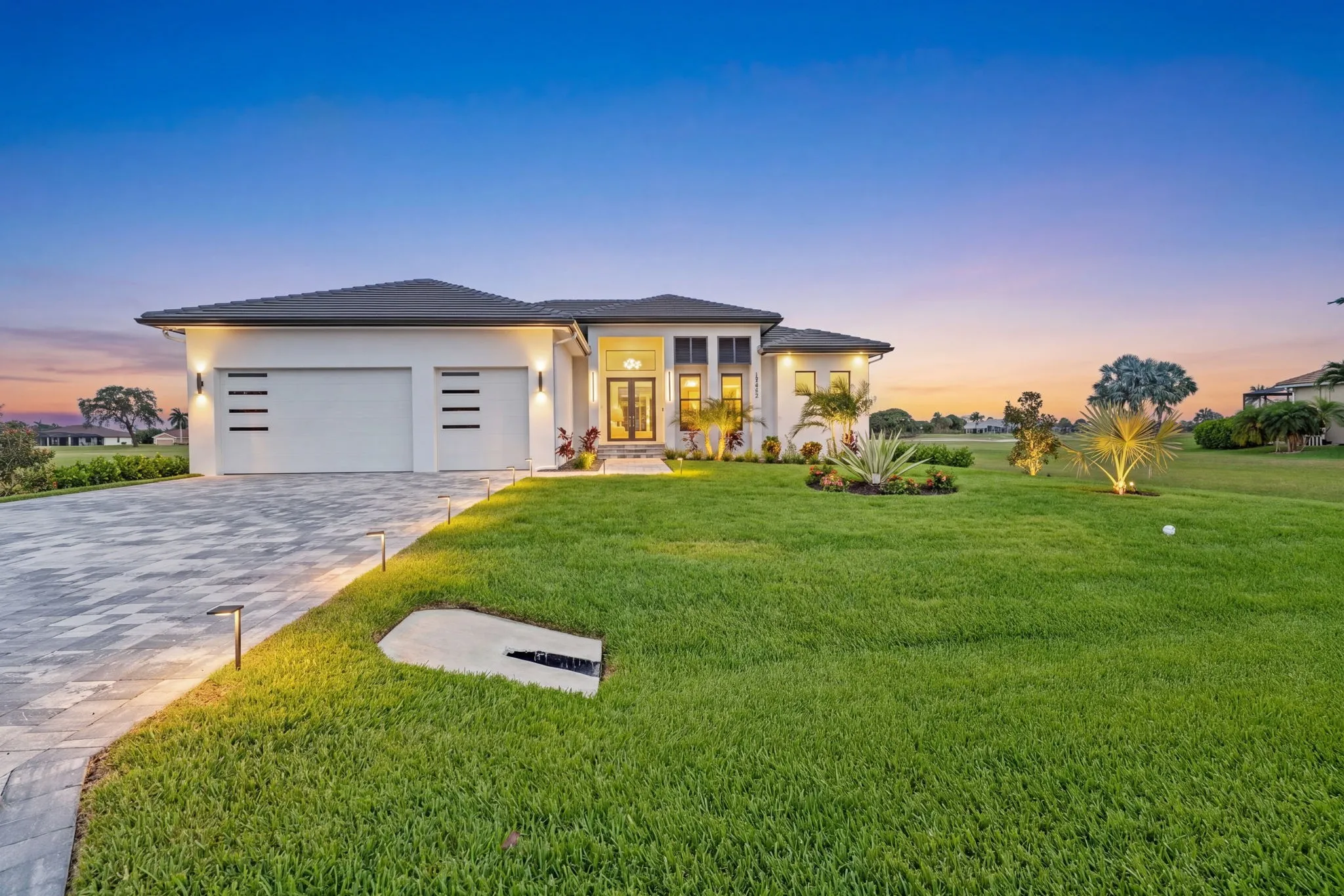 The same home edited into a twilight scene with the lights on