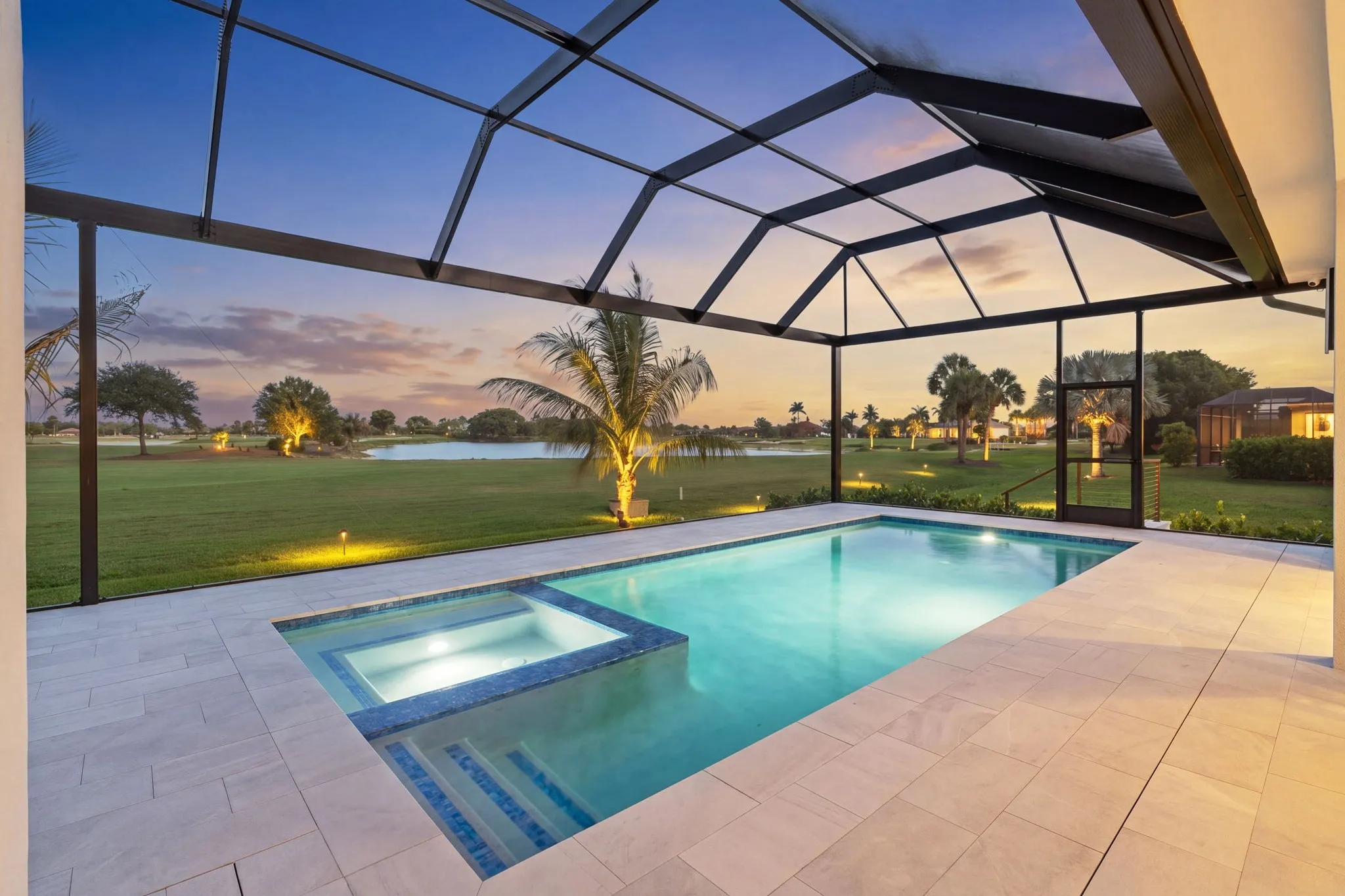 The same pool edited into a twilight scene with the pool and landscape lights on